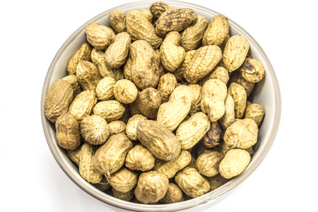 peanuts in cup closeup isolated white background