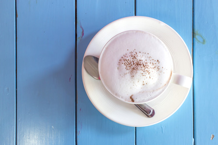 Coffee cup on blue tableの写真素材