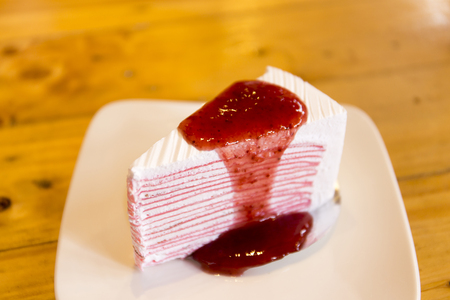 Crepe cake with strawberry sauceの写真素材