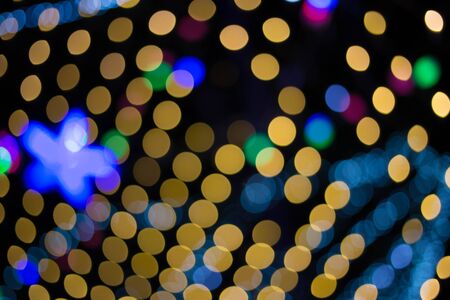 Lights blurred bokeh background from christmas night party for your design vintage or retro color...