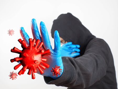 Man was defending himself and fighting the corona virus (Covid-19) and other diseases by wearing gloves and wearing a hygiene mask.の写真素材