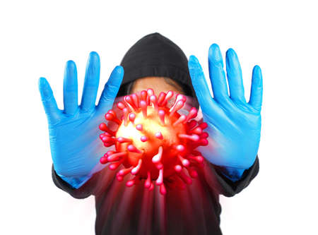 Man was defending himself and fighting the corona virus (Covid-19) and other diseases by wearing gloves and wearing a hygiene mask.の写真素材
