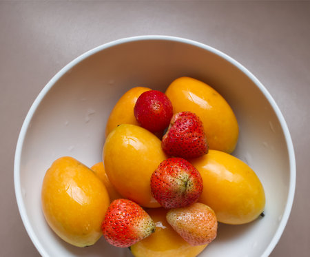 Marian Plum and Strawberry in White Bowlの写真素材
