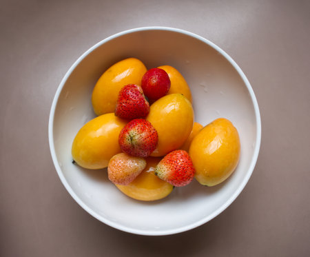 Marian Plum and Strawberry in White Bowlの写真素材