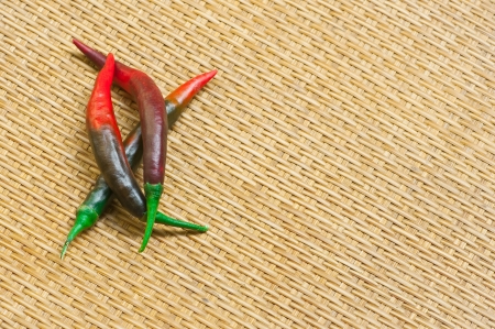 red and green hot pepper in bamboo trayの写真素材