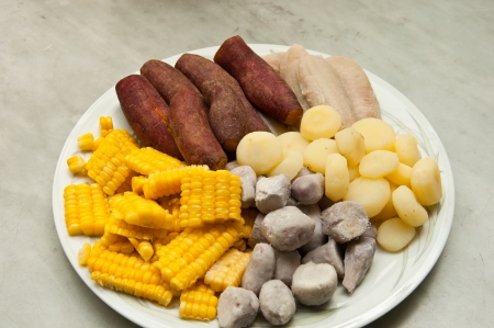 Sweet potatoes, taro roots, boiled banana, truffle and cornの写真素材