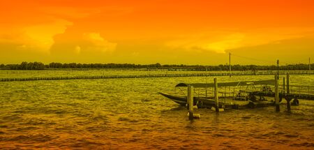 Long tail boat parking at pier in the sea, Bang Khun Thian Bangkok Thailandの写真素材
