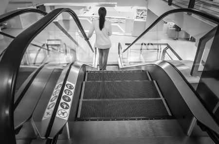 People going down escalator in Department Store - rear view, At Central Department Store Bangna-Trad road Bangkok Thailand, December 18, 2018の写真素材