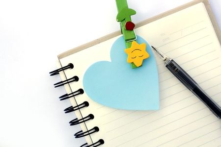 notebook and paper note with a pen 