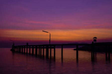 See the sun in the morning on the wooden bridge.の写真素材