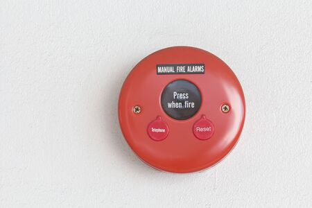 Manual Fire alarms and telephte on a white wall