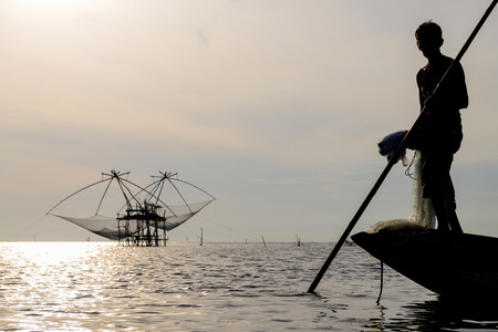 Fisherman of Bangpra Lake in action when fishing, Thailandの写真素材