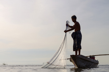 Fisherman of Bangpra Lake in action when fishing, Thailandのeditorial素材