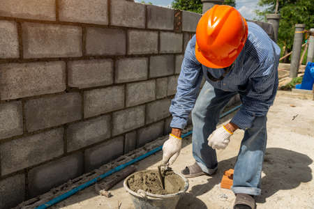 Empty mortar mixer and tools,  Cement mix concrete is compacted sand by spade for construction
