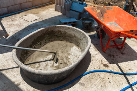 Empty mortar mixer and tools,  Cement mix concrete is compacted sand by spade for construction