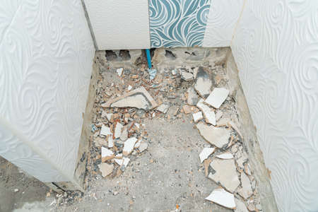 Worker remove, demolish old tiles a bathroom with jackhammer,  toilet repair,  remodeling,...