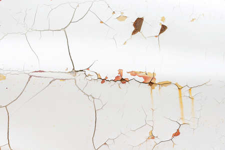 Peeling paint of old rusty car, Durable and weathered white metal surface.