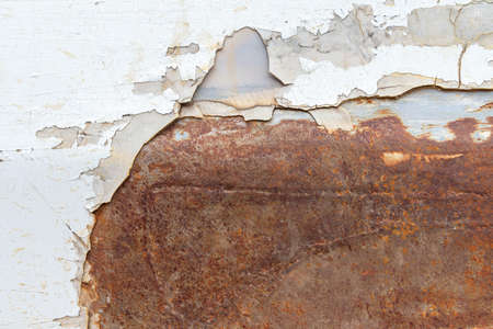 Peeling paint of old rusty car, Durable and weathered white metal surface.の写真素材