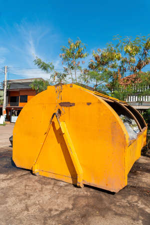 Yellow tub truck as a temporary garbage dump, A skip full of rubbish