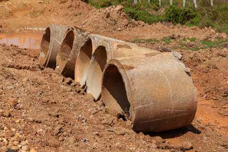 Old broken concrete cement pipe in grass,  Old concrete pipes, Cracked and deteriorated sewer pipes...