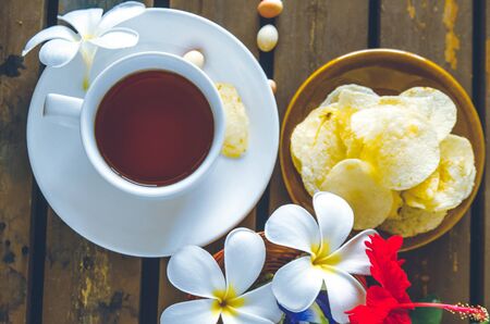 cups of tea with Plumeria on wooden tableの写真素材