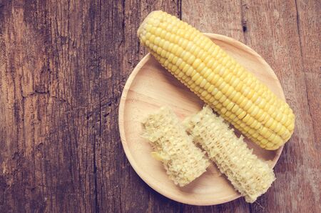 Boiled corn on a plate woodenの写真素材