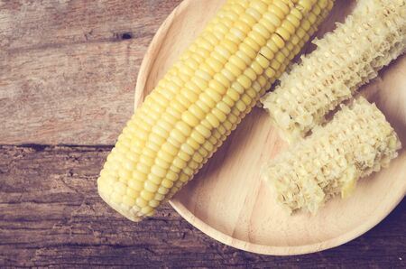 Boiled corn on a plate woodenの写真素材