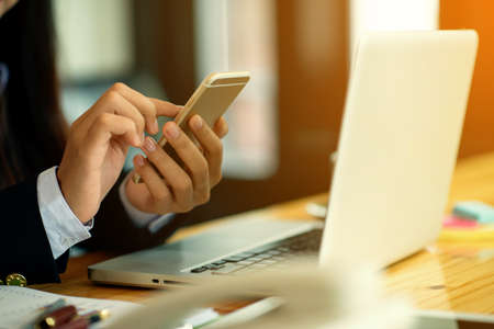 Close up young Asia woman working with tablet in office,Portrait of businesswoman with phone writes...