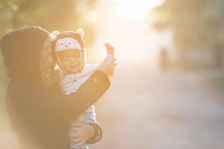 Asian family with mother and son is a happy and smiling with a sunrise time.Concept of friendly family.の写真素材