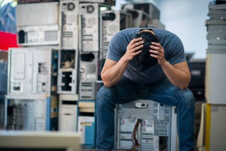 Sad asian technician man with old computerの写真素材