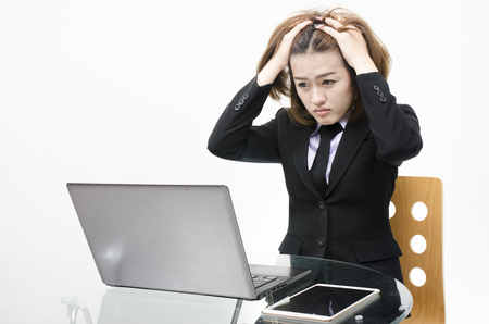 Business women worry about her work look so serious, Looking computer on table in office with tabletの写真素材