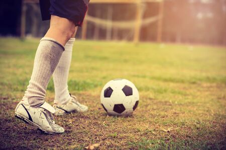 Close up soccer player hits a ball in football cupの写真素材