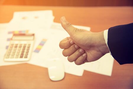 Close up thumbs of different business people pointing upの写真素材