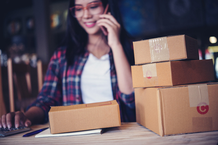 Young entrepreneur, teenager business owner work at home, box for delivery