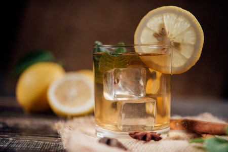 Glasses of  tea with lemon,Sliced lemons on a chopping boardの写真素材