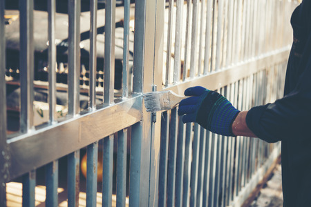Construction worker painting fence at home, closeupの写真素材