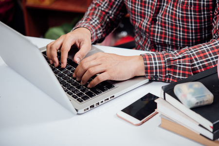 Young man using laptop in the home,Education conceptの写真素材