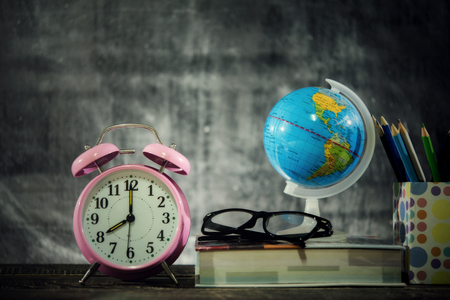 Education or back to school Concept.world globe,books, glasses, pencils, over chalkboard background.の写真素材