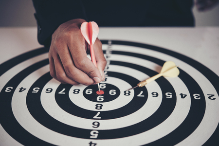 Businessman holding a darts aiming at the targeting the business conceptの写真素材