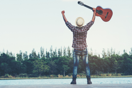 adult handsome musician holding acoustic guitarの写真素材