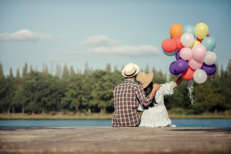 Portrait of a couple in love with balloons colorfulの写真素材