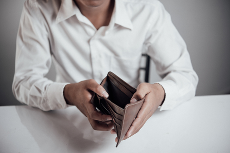 businessman saving money, Close up man carrying a wallet in hand, the dollar,finance accounting conceptの写真素材