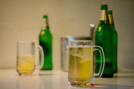Glass of light beer on a dark pub and Barの写真素材