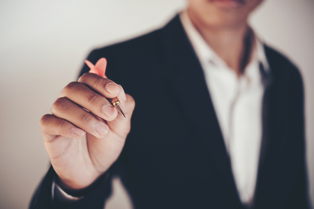Businessman holding a darts aiming at the targeting the business conceptの写真素材