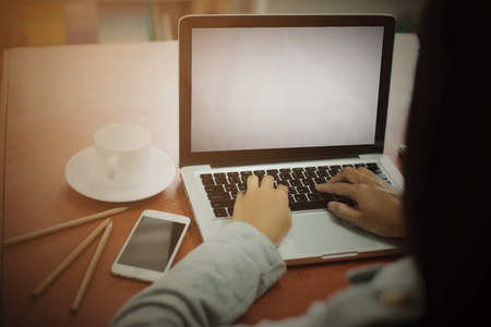 Close up of a beautiful young businesswoman and  laptop screenの写真素材