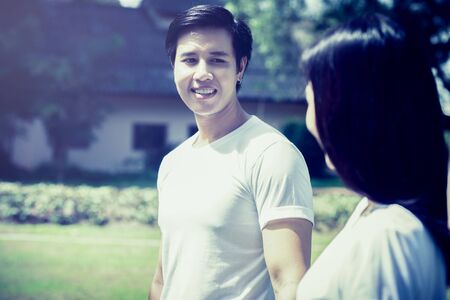 Portrait of a happy young couple enjoying a day in the park together with sunlight