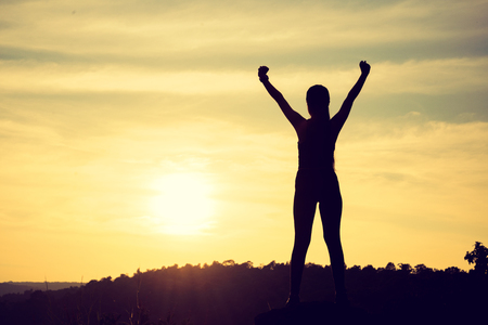Winner sport women silhouette on the mountain top. Sport and active life conceptの写真素材