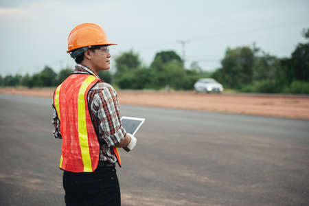Construction engineer supervising work at construction site