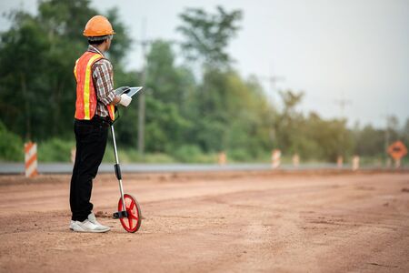 Construction engineer supervising work at construction siteの写真素材