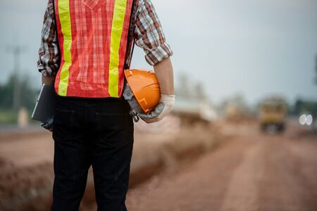 Construction engineer supervising work at construction siteの写真素材